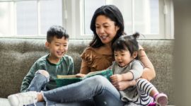 Mother teaching her children how to read